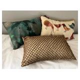 Three Decorative Throw Pillows With Various Design