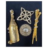 Four Vintage Brooches Featuring Gold Tones and Dec