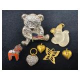 Small Jewelry Pieces Featuring Bear Pin, Charms, a