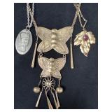 Three Silver-Tone Necklaces Featuring Unique Penda