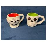 Two Halloween-Themed Coffee Mugs with Skeleton Des