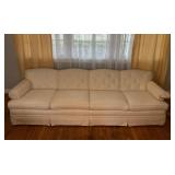 Ivory Tufted Sofa with Skirted Base and Wooden Leg