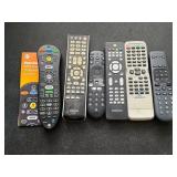 Six Remote Controls and a Stack of Empty CD/DVD Ca