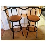 Two Black Metal Bar Stools with Tan Cushioned Seat