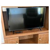 Vizio TV with Remote Control in Wooden Entertainme