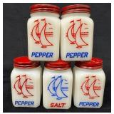 Four Hazel Atlas Milk Glass Pepper Shakers and One