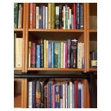Three Shelves of Books Covering Various Topics