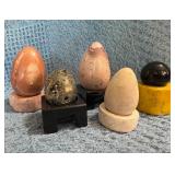 Four Stone Eggs, One Stone Sphere, and Five Carved