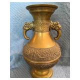 Ornate Brass Vase With Handles Featuring Decorativ