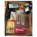 Office Supplies Including Pens, Staples, and Calcu