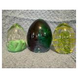 Three Glass Egg-Shaped Paperweights in Green and Y