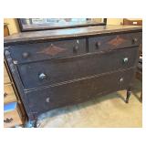Wooden Dresser With Ornate Detailing and Mirror