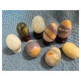 Eight Stone Eggs with Five Wooden Stands