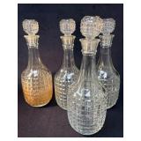 Four Pressed Glass Decanters with Stoppers
