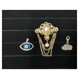 Three Jewelry Items: Gold-Tone Brooch, Evil Eye Pe