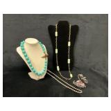 Four Assorted Necklaces in Various Materials and D
