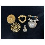 Six Decorative Brooches and Pendants in Metal and
