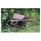 Rusty Metal Wheelbarrow with Wooden Handle