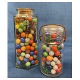 Two Glass Jars Filled With Marbles