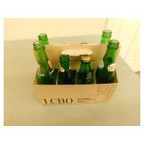 8 Pack of assorted green pop bottles
