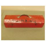 Red metal tool with plumbing supplies