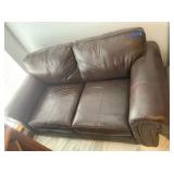 DARK BROWN LEATHER LOVESEAT WITH NAIL-HEAD TRIM;