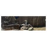 SELECTION OF YARD DECOR ITEMS ON AND IN FRONT OF