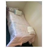 Twin Size Bed with Pink Quilt and Floral Pillows