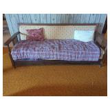 Wooden Settee with Plaid Blanket and Cushions