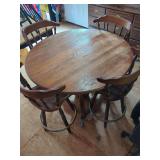 Round Wooden Dining Table with Four Swivel Chairs