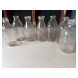 Six Embossed Milk Bottles