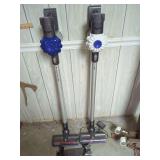 Two Dyson V8 Cord-Free Origin Vacuums with Charging Stations