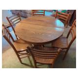 Round Oak Pedestal Dining Table with Four Slat-Back Chairs