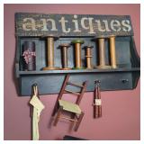 Wall-Mounted Display Shelf with Textile Spools and Decorative Accents