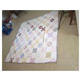 Patchwork Quilt with Multi-Color Fabric Blocks and White Background