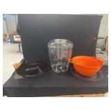 Kitchenware Assortment Including Clear Beverage Dispenser, Orange Colanders, and Glass Serving Plates