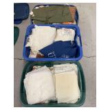 Textile Inventory Including Linens, Towels, and Decorative Pillows in Storage Totes