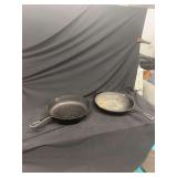 Two Cast Iron Skillets Featuring Lodge Branding and Size Markings