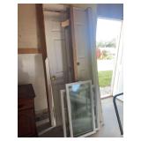 Assorted Building Materials Including Prehung Doors, Windows, and Jamb Components