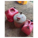 Three Red Fuel Containers Including One Metal and Two Plastic Cans