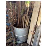 Metal Barrel Containing Assorted Long-Handled Agricultural Tools
