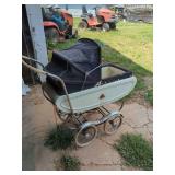 Classic Folding Baby Carriage with White Body, Black Hood, and Wire Spoke Wheels