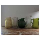Group of Five Molded Glass Pitchers
