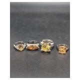 Group of Four Sterling Silver Ring Mountings with Faceted Colored Gemstones