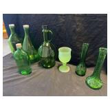 Green Glass Assortment Including Bottles, Vases, and a Frosted Goblet