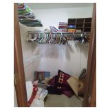 Closet Contents Including Linens, Books, Hangers, and Decor Items