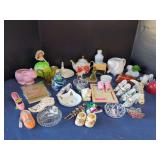 Mixed Decorative Grouping Featuring Porcelain Figurines, Glassware, and Collectible Shoes