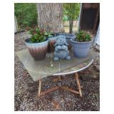 Garden Lot with Potted Plants, Concrete Dog Figurine, and Table