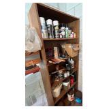 Wooden Bookshelf with Assorted Paint Cans and Painting Supplies