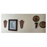 Assorted Wall Decor Including Framed Art, Brass Plates, and Pink Sculptural Accents